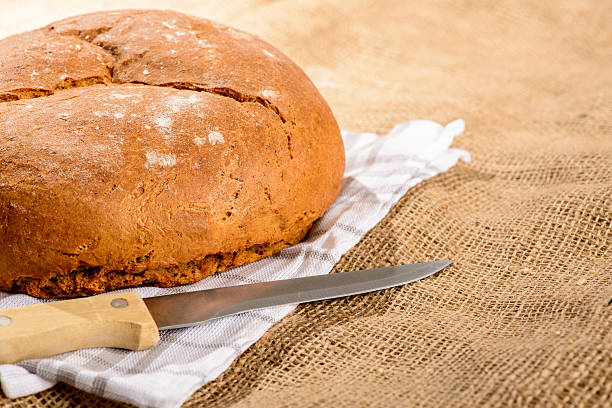 istock Image of bread loaf and knife 538720301