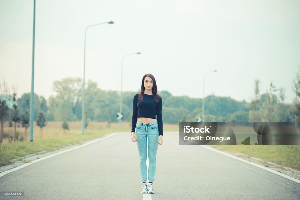 young beautiful brunette straight hair woman on the road young beautiful brunette straight hair woman on the road outdoor 2015 Stock Photo