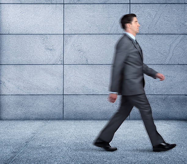 istock Blurred Businessman Walking On Sidewalk 538723803
