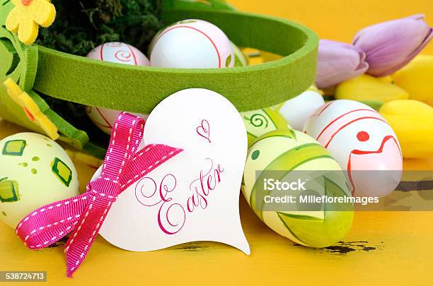 Happy Easter Eggs In Basket On Yellow Wood Stock Photo - Download Image Now - 2015, Basket, Easter