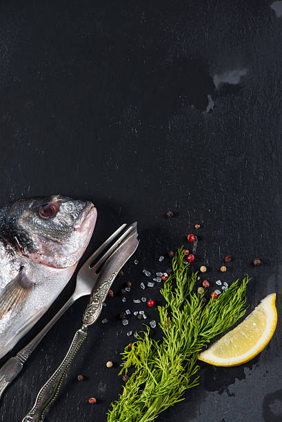 istock Fresh whole sea fish with aromatic herbs, cooking concept 538725763