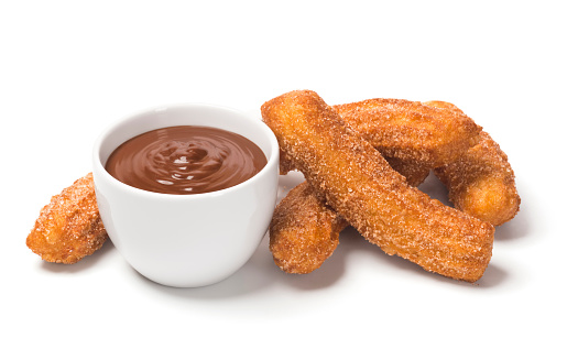 Churros are sticks of fried dough (sometimes called Spanish doughnuts) rolled in cinnamon and sugar that originate from Spain. They are frequently eaten for breakfast and served with a mug of hot chocolate. This 
