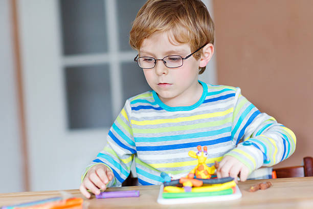 istock Happy little child, adorable creative kid boy playing with dough 538727911
