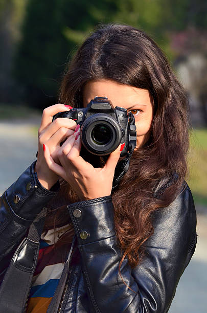 istock Young woman with DSLR camera 538745627