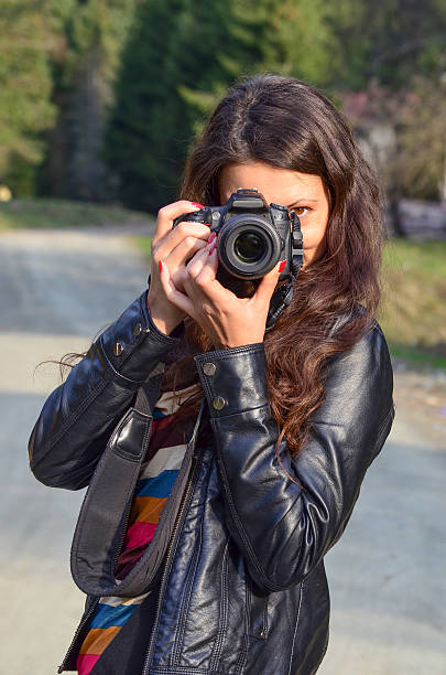 istock Girl with DSLR camera 538745643