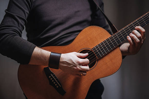 istock Man playing on acoustic vintage guitar 538746891