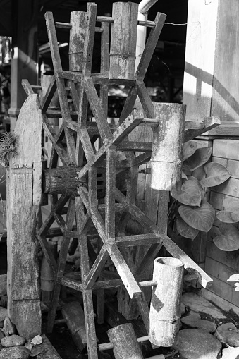 old asian wooden water wheel decorating in the garden