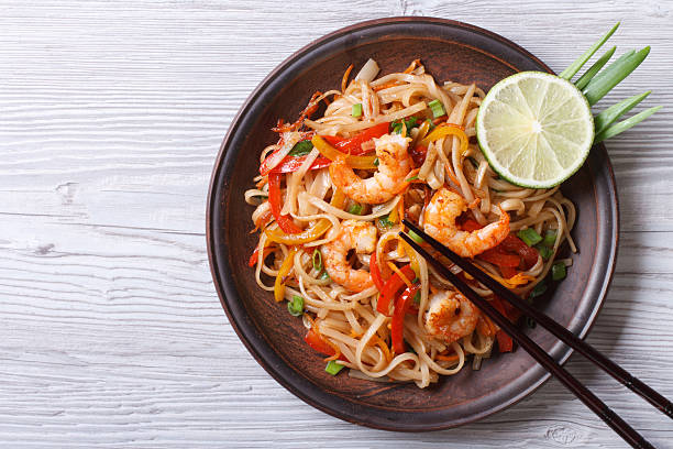 istock Rice noodles with shrimps and vegetables top view 538750385