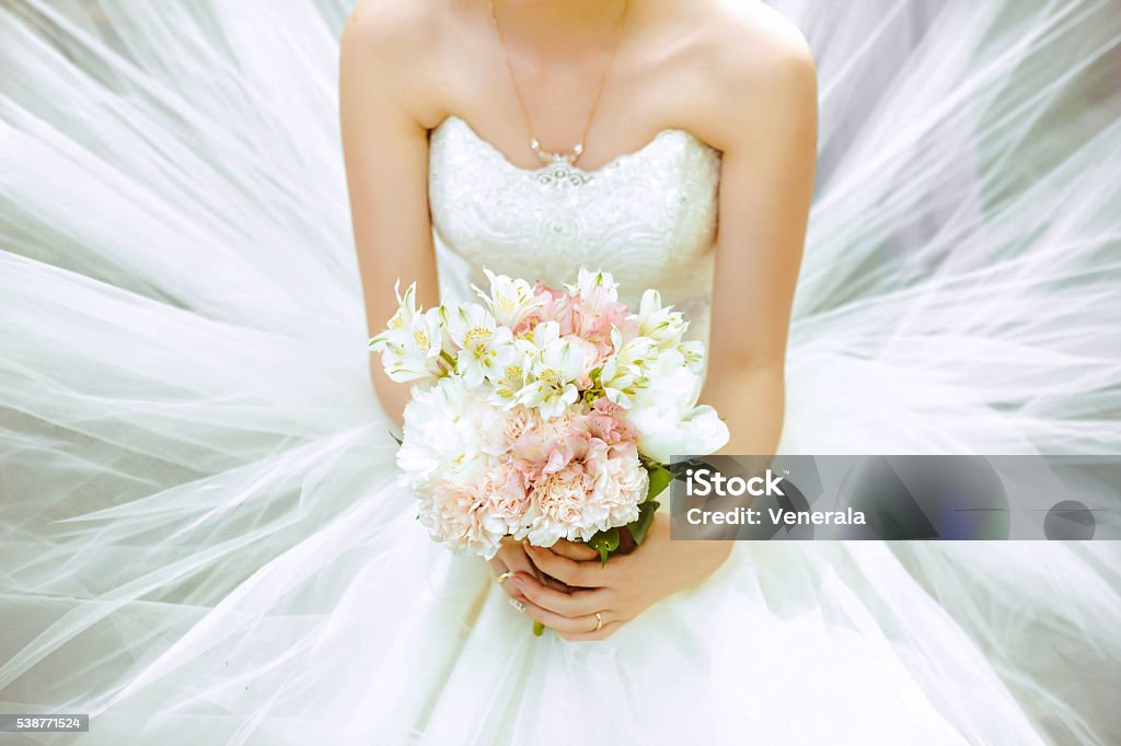 The bride's bouquet Bouquet of the bride in a magnificent white dress. Wedding Stock Photo