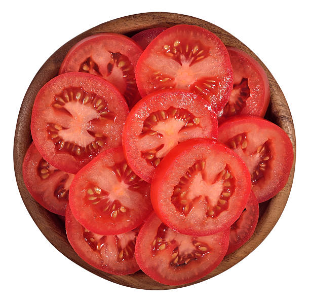 istock Tomato slices in a wooden bowl on a white 538772577