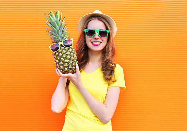 istock Pretty cool girl in sunglasses with pineapple having fun 538773858