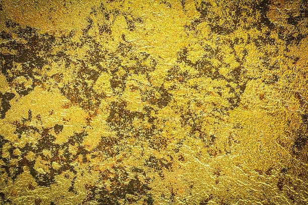 istock Abstract background texture of stone wall in yellow gold tone. 538774090