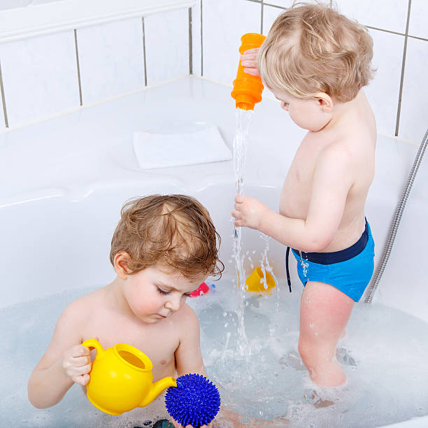 istock Two little sibling boys having fun with water 538774613