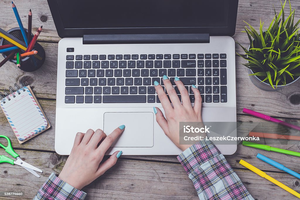 Overhead shot of woman working on laptop Overhead shot of woman working on laptop. Close up Adult Stock Photo