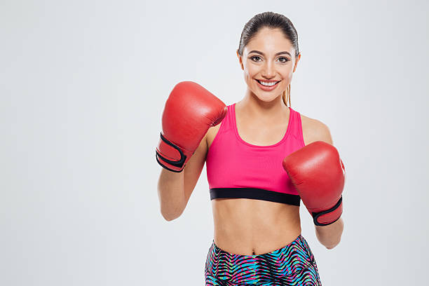 istock Smiling woman in boxing gloves looking at camera 538774960