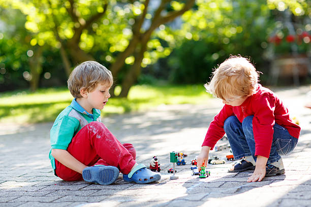 istock Two little kid boys playing with car toys 538775673