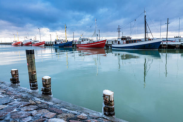 Fishing boats and Mole in Warnemuende (Germany).