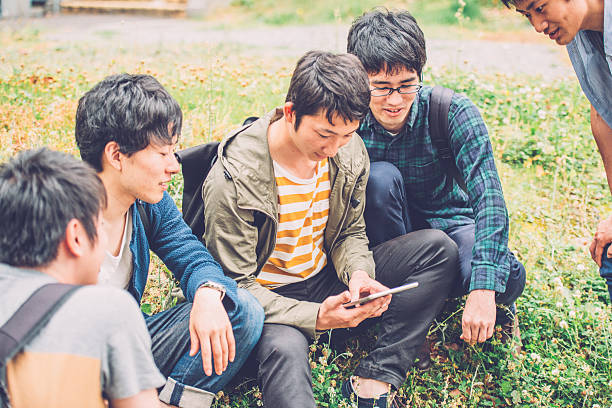 istock Five Japanese Students Using Digital Tablet, Campus Park, Kyoto, Japan 538777030