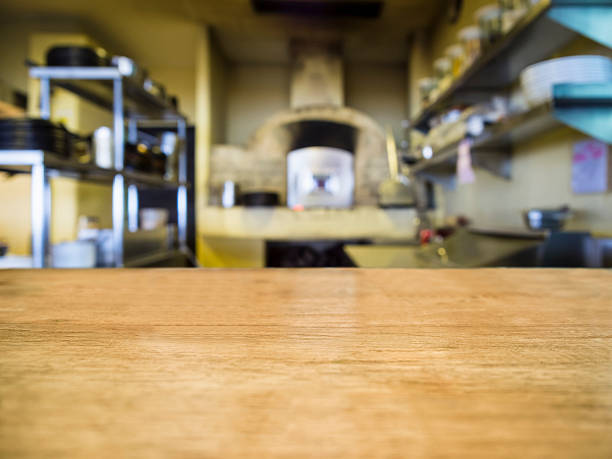 istock Top of Wooden Table with Blurred Kitchen Restaurant Background 538777069