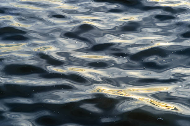 Dark blue flowing river water surface stock photo
