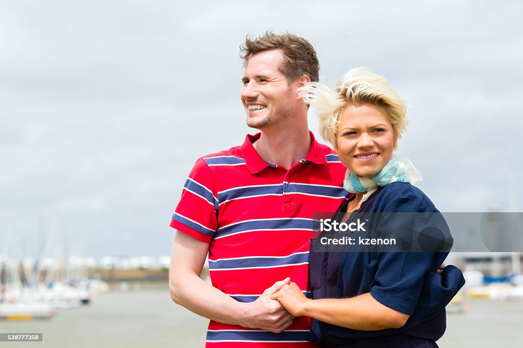 Couple hugging at marina pier Couple enjoying vacation at German north sea ship pier Adult Stock Photo