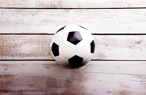 istock Soccer ball against wooden background. Studio shot. Copy space. 538777660