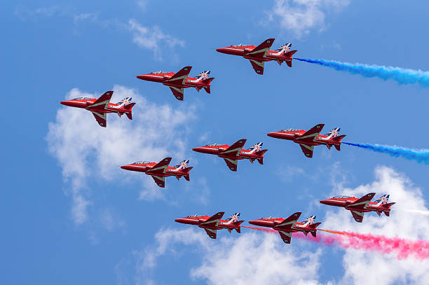 Royal Air Force Red Arrows Display Team Dawlish, United Kingdom - August 23, 2014: The Royal Airforce Red Arrows aerobatics display team perform in diamond formation at the Dawlish Airshow in Devon, England british aerospace stock pictures, royalty-free photos & images