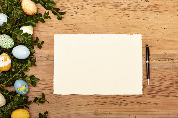 istock Easter eggs and twigs, blank card and ballpen on wood 538778261