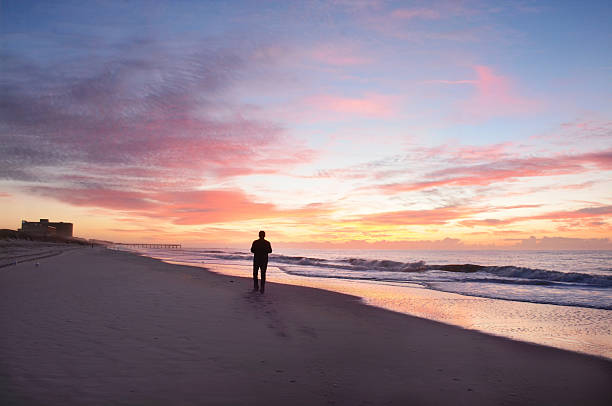 istock Man walking on beach at beautiful sunrise. 538778544