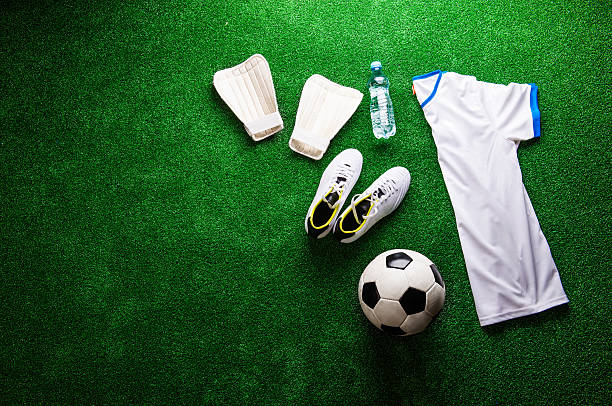 istock Soccer ball,cleats and various football stuff against artificial 538778644