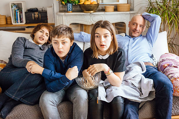 istock Surprised family of four watching television 538778726