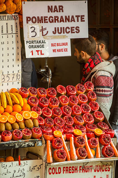 Istanbul, Turkey - October 20, 2014: Fresh Pomegranate juice for sale in Istanbul, vendors talking waiting fro customers