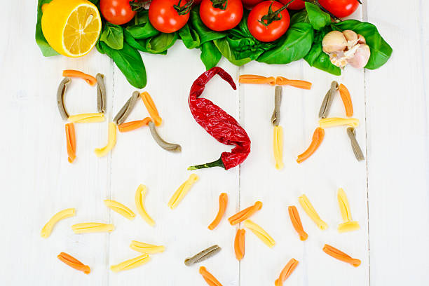 istock Basil, Red Cherry Tomato with Pasta on White Woody Background 538779640