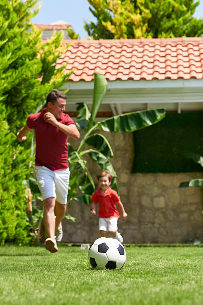 istock Father and son playing football 538779790