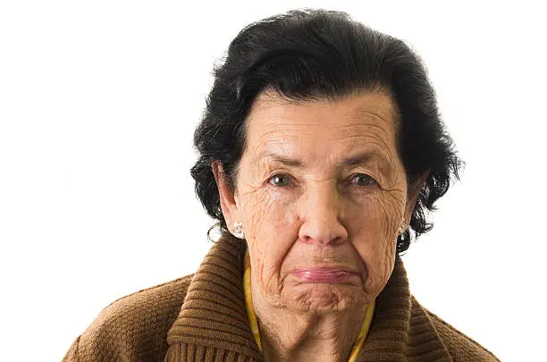 closeup portrait of old cranky grumpy sad woman grandmother