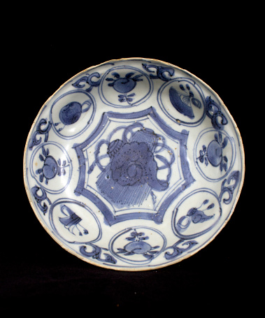 Blue and White Antique Chinese Plate on Black Background from a ship wreck