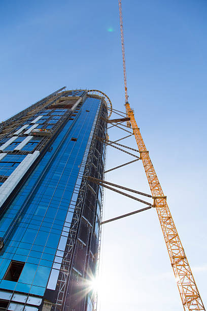 istock Huge crane rising near construction of a skyscraper 538780687