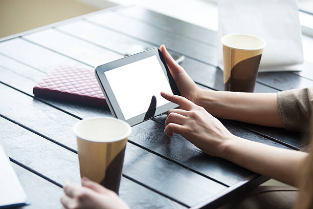 istock Women hands holding tablet with white blank screen in cafe 538780746