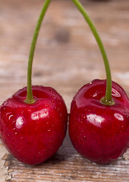 istock Fresh red Cherries on wooden table macro background 538781200