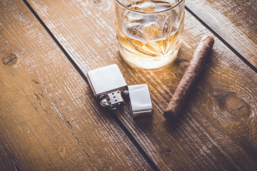 Cuban cigar and whiskey on an old wooden table