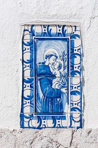 Saint Anthony of Lisbon A tile painting of Santo António ( European Portuguese) or Santo Antonio ( Brazilian Portuguese) in Lisbon, also known as St. Anthony of Padua, OFM ( Lisbon , 15 of August of 1191 - 1195 - Padua , 13 of June of 1231), of uncertain surname but baptized as Fernando, was a Doctor of the Church who lived at the turn of the centuries XII and XIII. His reputation for holiness led him to be canonized by the Catholic Church shortly after his death, distinguishing himself as a theologian , mystic , ascetic and especially as noted speaker and great miracle worker . Antonio is also considered one of the most remarkable intellectuals of Portugal's pre-university period. st anthony of padua stock pictures, royalty-free photos & images