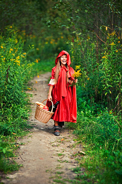 istock Happy Little Red Riding Hood walking in forest 538792194
