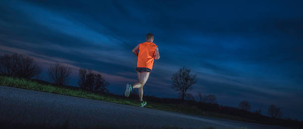 istock Male runner on the road in the evening 538797236