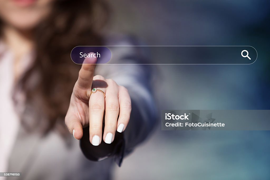 Searching on the internet. Woman surfing the internet by pressing search button on browser tab on virtual touch screen. Searching Stock Photo