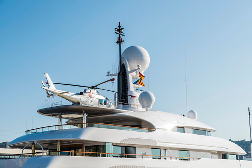 Yacht with a helicopter on its deck at the marina in Barcelona, Catalonia, Spain