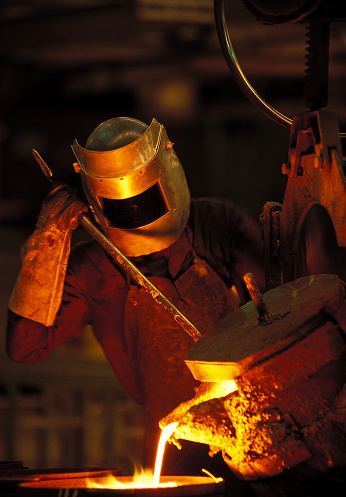 Man wearing a protective mask working in a siderurgy