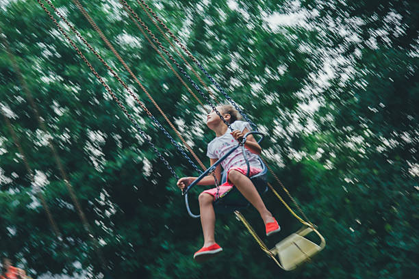 istock girl riding on chained carousel 538799482
