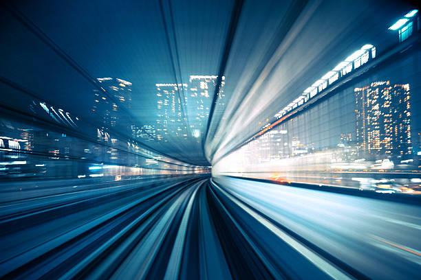 Motion blur of train moving to City abstract motion-blurred view from the front of a train in Tokio, Japan light commercial vehicle stock pictures, royalty-free photos & images