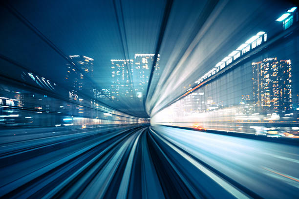 Motion blur of train moving to City abstract motion-blurred view from the front of a train in Tokio, Japan tokyo bullet train stock pictures, royalty-free photos & images