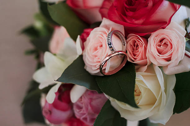 istock wedding rings on a wedding bouquet. 538802282